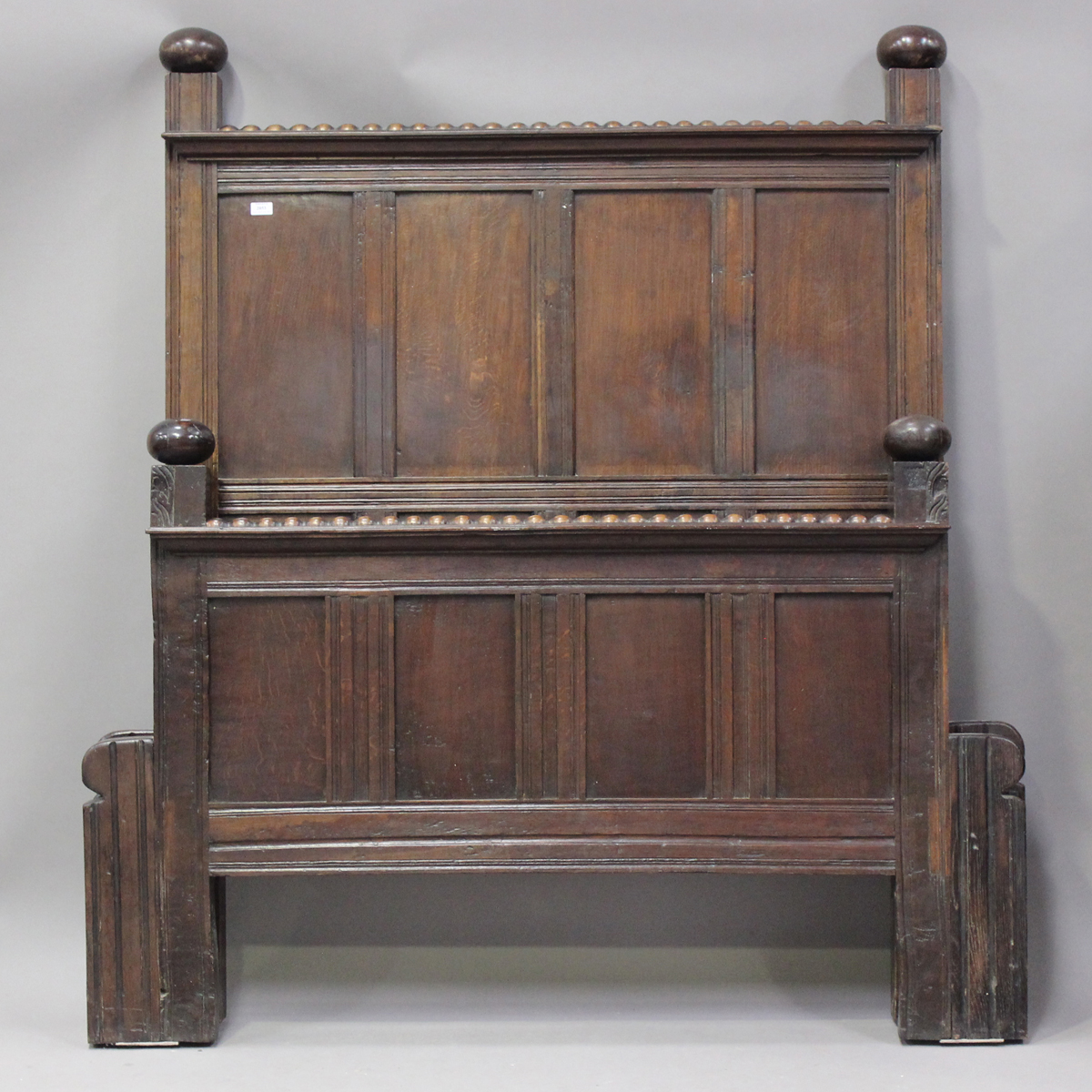 A 20th century oak panelled double bed frame, formed from 18th century oak panelling, height