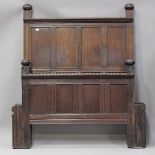 A 20th century oak panelled double bed frame, formed from 18th century oak panelling, height
