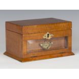 An Edwardian satin mahogany jewellery casket, the hinged lid and glazed fall-front enclosing a