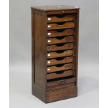 A George V oak tambour-front filing cabinet, fitted with nine internal drawers, height 111cm,