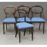 A set of six Victorian mahogany balloon back chairs, the seats upholstered in pink fabric, on turned