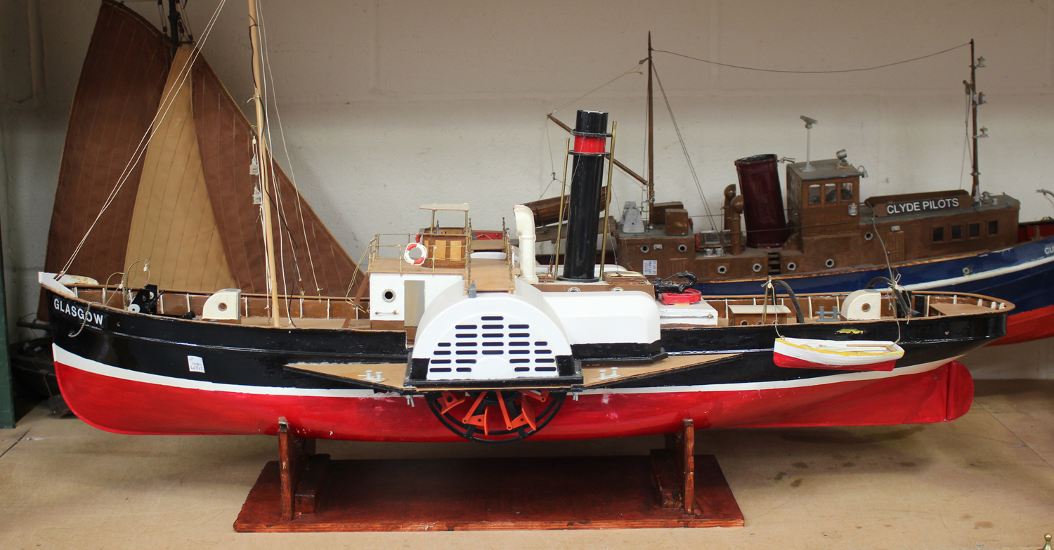 A late 20th century plastic, wooden and metal model of a paddle steamer, length 100cm, together with