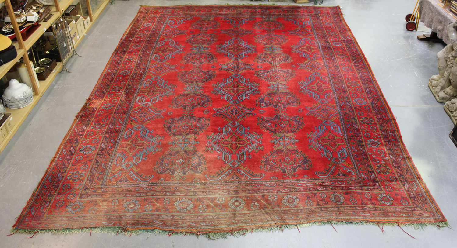 A large Turkish 'Old Turkey' carpet, early 20th century, the red field with overall palmettes and