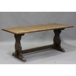 A 20th century oak refectory table, the rectangular top raised on shaped supports, height 75cm,