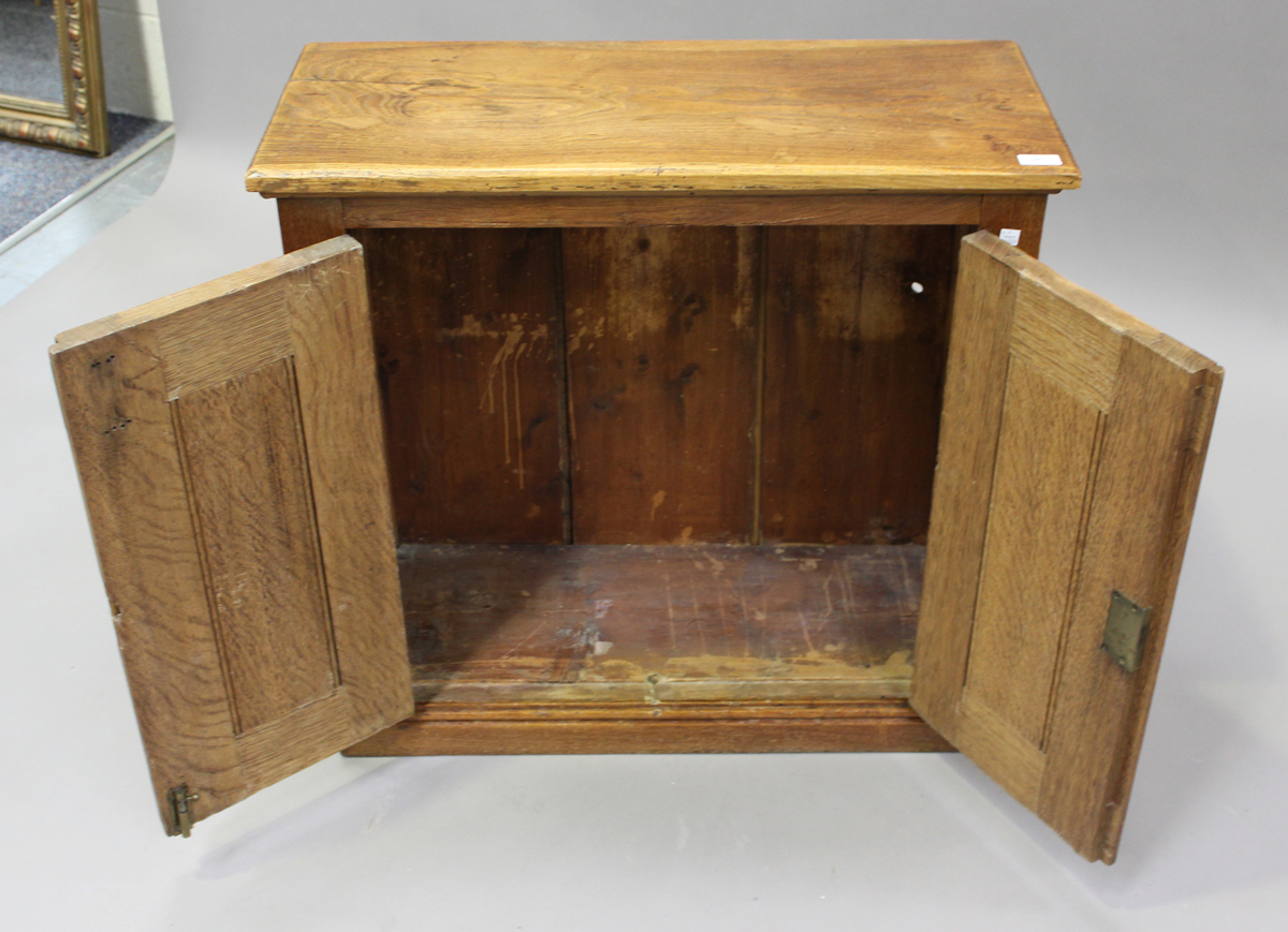 A late 20th century pale oak two-door side cabinet, fitted with carrying handles, on a plinth - Image 3 of 4