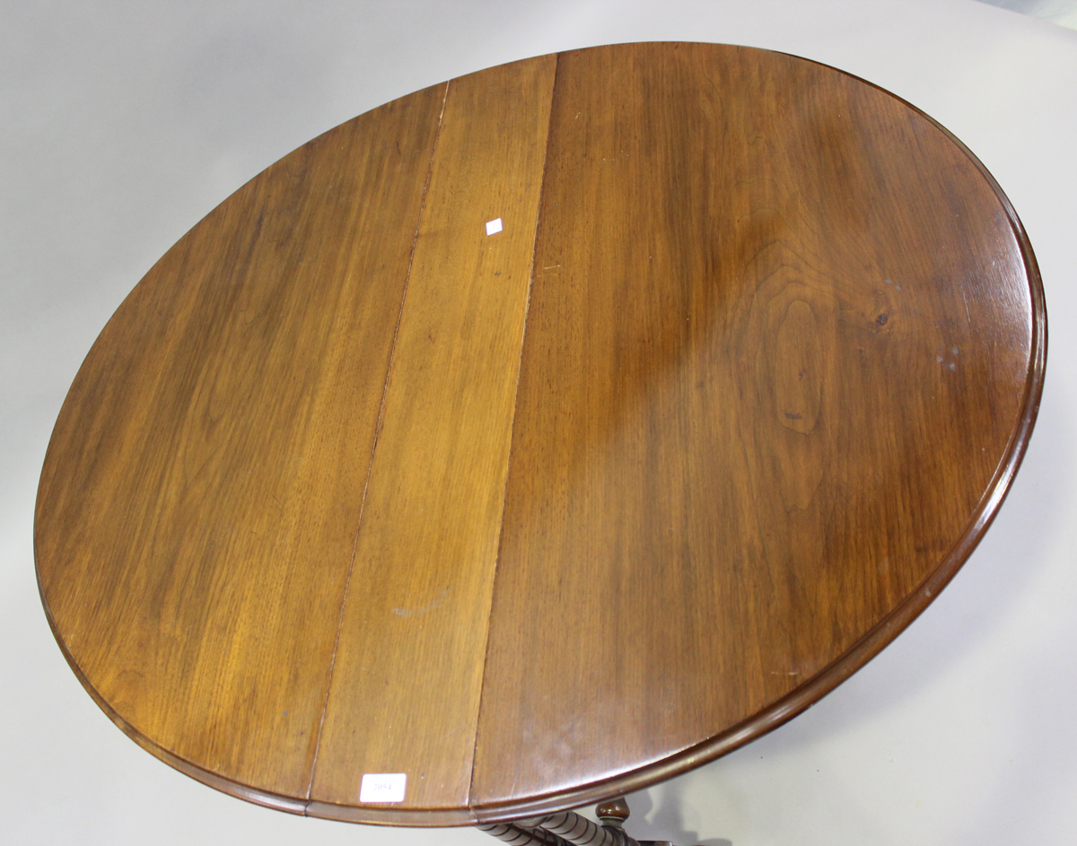A late Victorian walnut oval Sutherland table, on spiral fluted legs and brass castors, height 73cm, - Image 3 of 4
