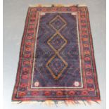 A Beluche rug, Afghan/Persian borders, mid-20th century, the aubergine field with three hooked