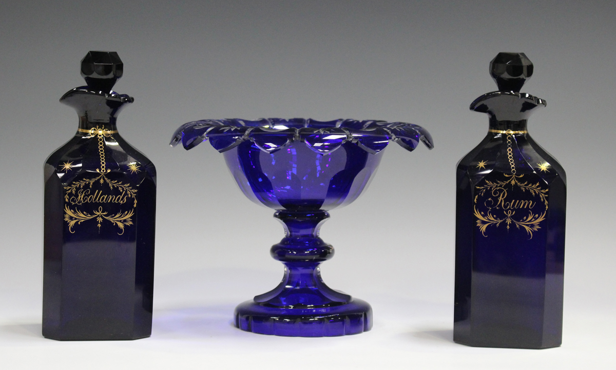 A pair of Bristol blue glass square chamfered decanter and stoppers, circa 1840, gilt with labels