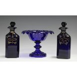 A pair of Bristol blue glass square chamfered decanter and stoppers, circa 1840, gilt with labels