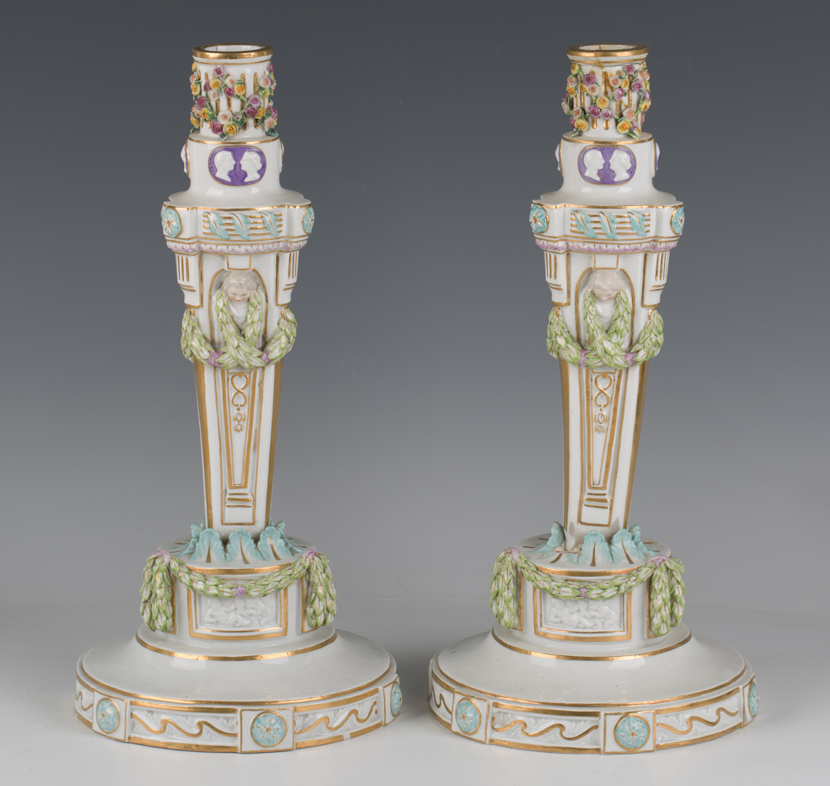 A pair of Meissen candlesticks, 19th century, modelled after Leuteritz as a triangular stem hung