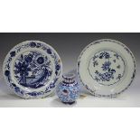 A Dutch Delft plate, 19th century, blue painted with flowers, diameter 22.5cm, together with an