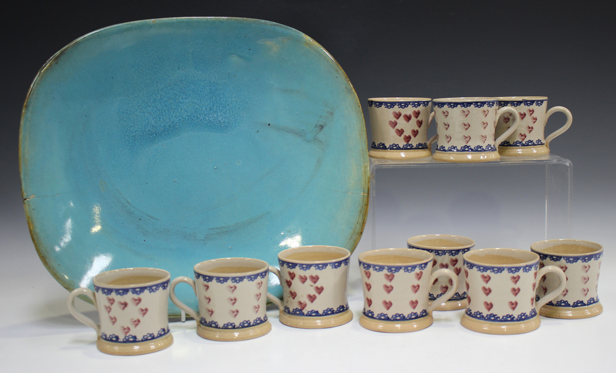 Ten Nicholas Mosse Pottery small mugs, painted with hearts within blue banding, black printed marks,