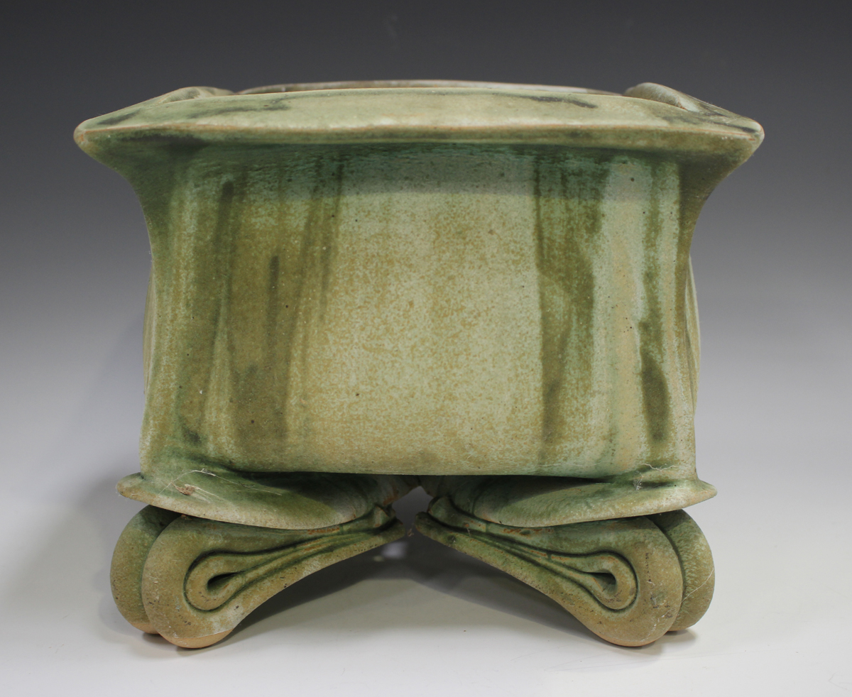 A John Alliston studio pottery square planter, late 20th century, raised on four stylized folded