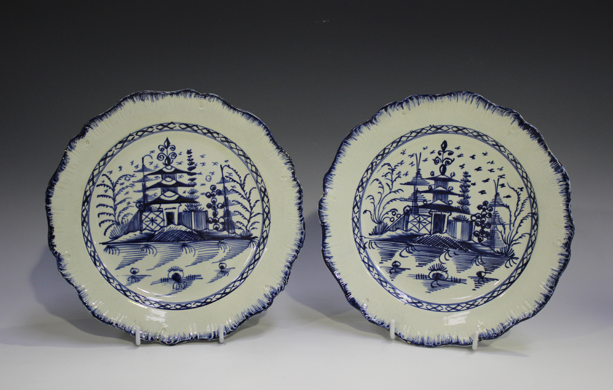 A pair of English pearlware plates, circa 1790, each painted in blue with a chinoiserie pagoda