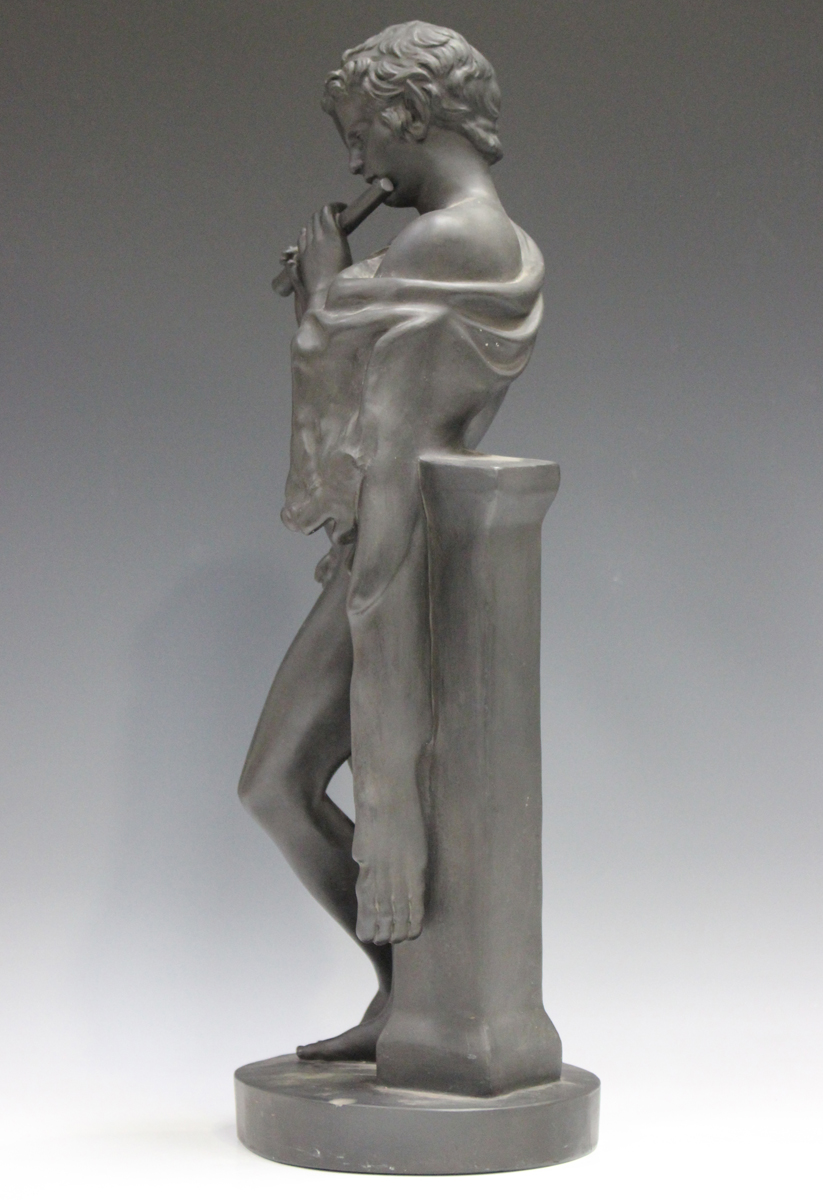 A Danish black basalt figure of a boy playing a flute, circa 1900, modelled leaning against a - Image 4 of 6