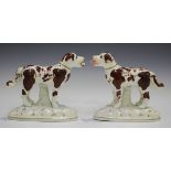 An unusual pair of Staffordshire pottery dogs, mid to late 19th century, standing four square on