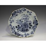 An English Delft octagonal plate, 18th century, painted in blue with a chinoiserie landscape