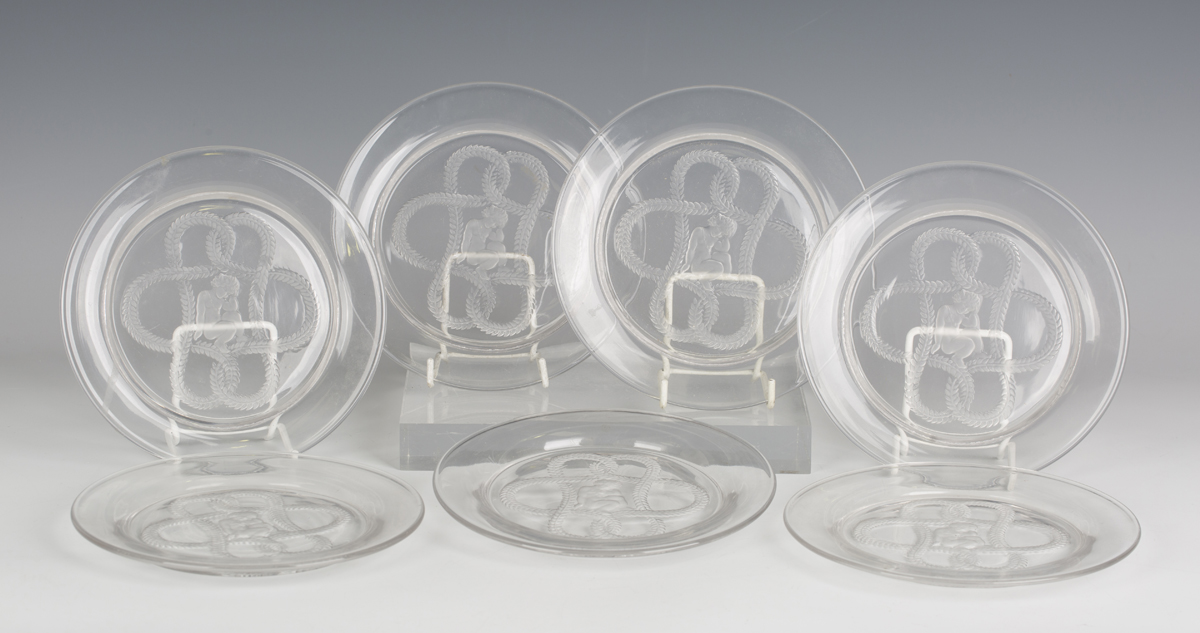 Seven Lalique clear and frosted glass Olympe pattern plates, circa 1940, each centre decorated