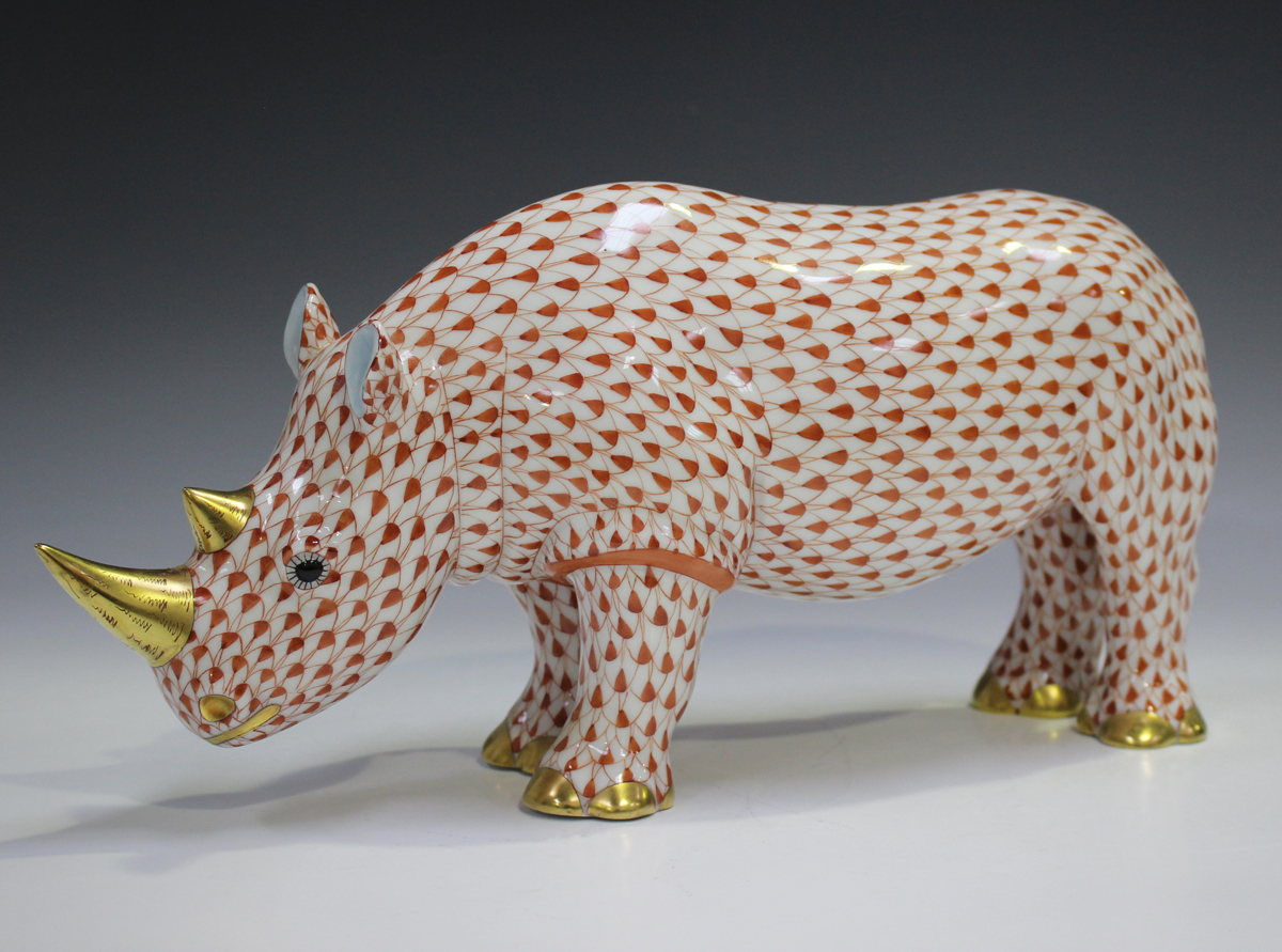 A large Herend porcelain rhinoceros with iron red scale decoration, impressed and printed marks to