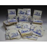 A group of approximately eighty Dutch Delft blue and white tiles, late 19th/early 20th century, each