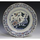 An English Delft charger, Bristol, 18th century, painted in blue, green and red with a chinoiserie