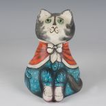 An early Joan and David De Bethel Rye papier-mâché cat, dated 1966, seated wearing a blue dress