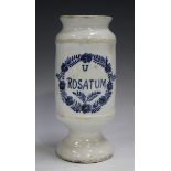 A tin glazed cylindrical dry drug jar, 19th century, inscribed in blue 'U Rosatum' within a