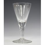 A large plain stem wine glass, 18th century, the drawn trumpet bowl raised on a teared plain stem