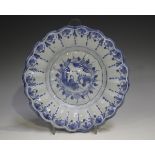 A Delft moulded dish, 18th century, painted in blue with a chinoiserie style figure within a