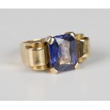 A gold ring, circa 1950, claw set with a cut cornered rectangular synthetic sapphire between