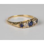 A gold, sapphire and diamond five stone ring, mounted with three cushion cut sapphires alternating