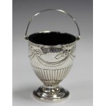 A George III silver basket with reeded swing handle, the half-reeded ovoid body embossed with ribbon