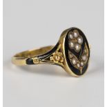A Victorian 18ct gold, black enamelled and seed pearl mourning ring, designed as a forget-me-knot