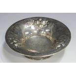 A Norwegian .830 silver circular dish by David Andersen, the flared rim embossed with fruit, on a
