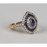 An 18ct gold, sapphire and diamond cluster ring, mounted with the principal oval cut sapphire within