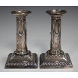 A pair of late Victorian silver candlesticks, each detachable nozzle with beaded rim, the slightly