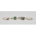 A gold ring, mounted with a rectangular cut pale emerald, weight 1.6g, a turquoise and garnet
