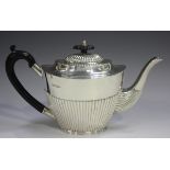 A late Victorian silver teapot of half-reeded oval tapering form, Sheffield 1897 by Mappin & Webb,