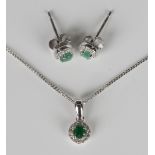 A white gold, emerald and diamond cluster pendant, detailed '375', length 1.1cm, on a 9ct white gold