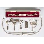 A group of silver jewellery, comprising a brooch, designed as a tied bow with a pendant heart and