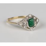 A gold, emerald and diamond ring, collet set with the cut cornered rectangular step cut emerald