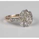 A gold and diamond cluster ring, mounted with the principal cushion cut diamond within a surround of