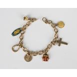 A 9ct gold oval link charm bracelet, fitted with seven pendants and charms, including a gold and