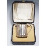 A George V silver christening tankard with scroll handle, Birmingham 1927 by Saunders & Mackenzie,