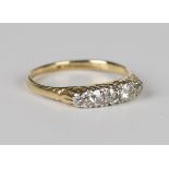 A gold and diamond five stone ring, mounted with a row of cushion cut diamonds, detailed '18ct',