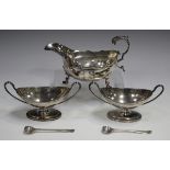 A pair of Victorian silver table salts, each of oval boat shaped form with reeded rims and loop