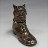 A George V silver novelty inkwell, modelled as a cat in a shoe, the cat's head forming the hinged