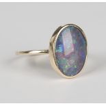 A gold ring, mounted with an oval opal doublet, unmarked, weight 4.4g, ring size approx Q1/2, with a