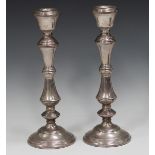 A pair of Elizabeth II silver candlesticks with turned stems and circular bases, Birmingham 1977
