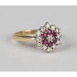 An 18ct gold, diamond and ruby hexagonal cluster ring, mounted with a circular cut diamond within